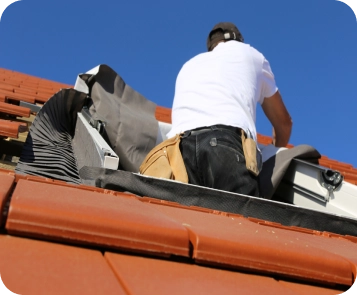 Instalación de Claraboyas en Guadalajara 10 Técnico instalando un tragaluz VELUX en un tejado de tejas en Guadalajara